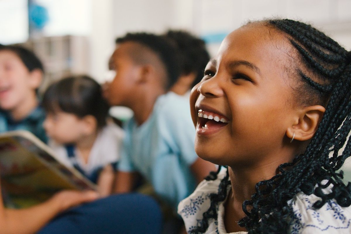A student laughing during story time in class